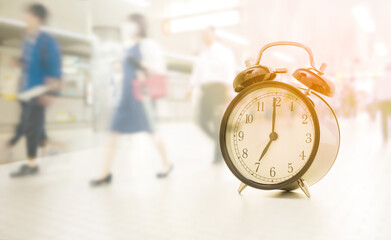 Double exposure of Vintage clock at seven o'clock and blurred image of people traveling
