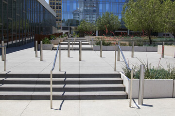 Sidewalk path of travel and hand rails at downtown building entrance