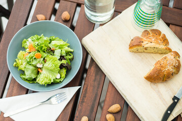 Fresh lettuce salad with bread on the table for lunch