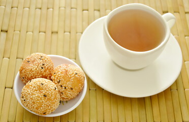 fried glutinous ball topping sesame stuffed mushed yellow bean with tea cup