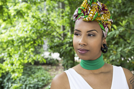 Portrait of young woman with piercings wearing traditional Brazilian headgear