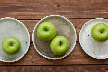 fresh organic green fruits with apples on wooden background top view