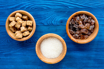 sugar lumps for sweet food cooking on kitchen blue table top view