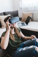 Beautiful young woman enjoying virtual reality at her home. 