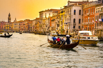 VENICE, ITALY - circa MARCH, 2016: Eight person crew is training on a rowing boat at sunset, sunrise in Venice, Italy