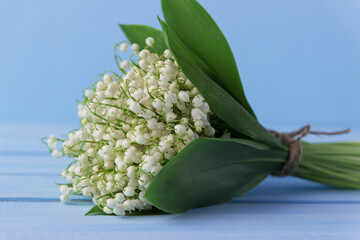 Obraz premium Lily of the valley on wooden background. Lily of the valley bouquet