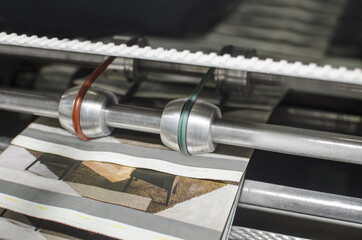 Closeup detail of Printing machine during magazine print production from offset roo paper