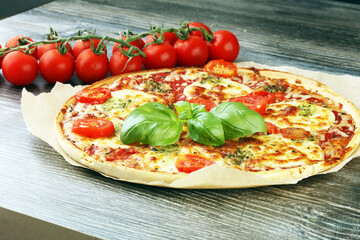 Hot true ITALIAN PIZZA with basil and cheese. TOP VIEW Tasty traditional pepperoni pizza on board on wooden table with decoration