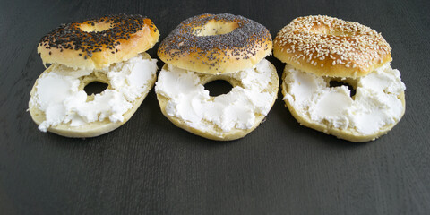 bagels with sesame seeds on a black background