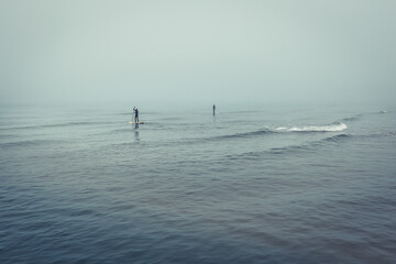 Surfers in the fog near Lokken