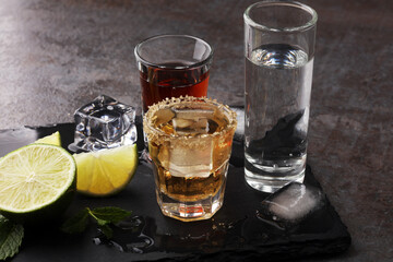 Selection of alcoholic drinks on rustic stone plate