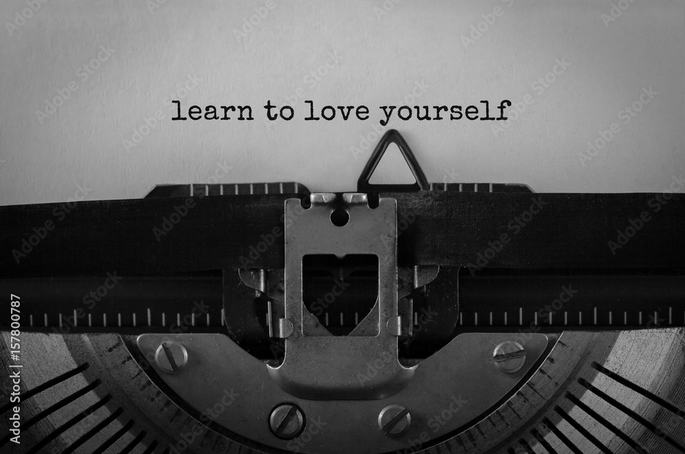 Wall mural Text Learn to love yourself typed on retro typewriter