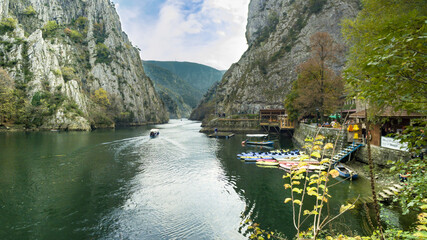 View of beautiful tourist attraction, boat on lake at Matka Canyon in the Skopje surroundings. Macedonia - obrazy, fototapety, plakaty