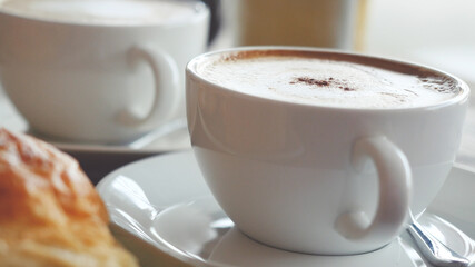 Cappuccino with a French roll for breakfast
