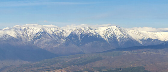 Panorama of snowy mountain peaks range