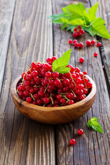 Berries red currants on a wooden background.