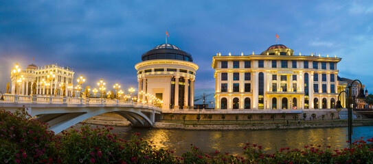 Fototapeta premium Panoramic night view of Skopje City Center at evening. Architecture and buildings of Skopje City - the capital of the Republic of Macedonia (FYROM). Balkan Peninsula. Southeast Europe