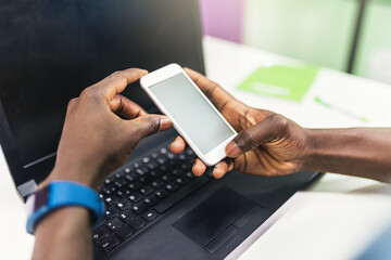 Close up of black hands using mobile.