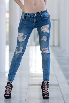 legs of young woman in jeans, girl in fashionable shoes