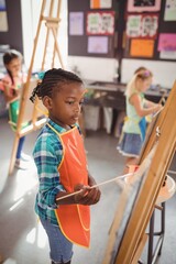Attentive girl panting on canvas