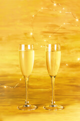 Two glasses of champagne on blurred golden background