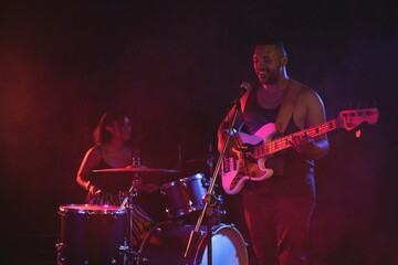 Male singer and female drummer performing