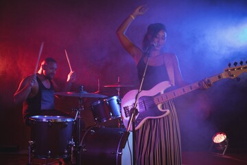 Fototapeta na wymiar Singer and drummer performing in nightclub