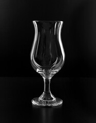 Classic cocktail empty hurricane glass isolated on black background