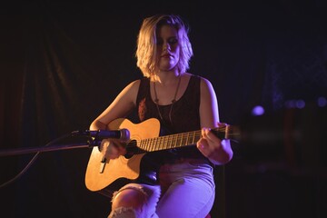 Obraz premium Female guitarist performing in music concert