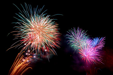 fireworks new year celebrate -  beautiful colorful firework isolated display with light reflex in water display for celebration happy new year and merry christmas on black  background