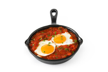 Mexican breakfast: Huevos rancheros in iron frying pan isolated on white background
