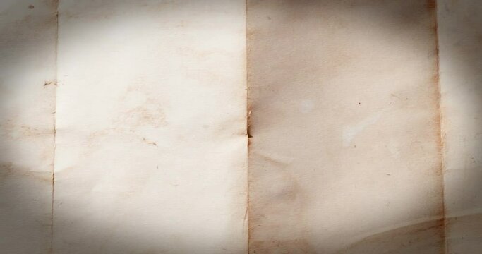 Zoom out from old retro and vintage folded empty page of paper on wooden table. Good for old pirate map template