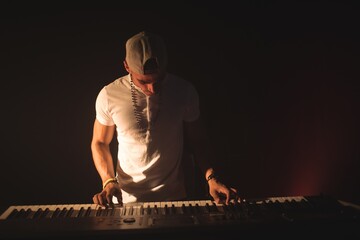 Male musician playing piano in nightclub