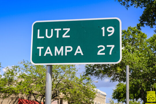 Green and white mile marker to Lutz and Tampa in SW Florida