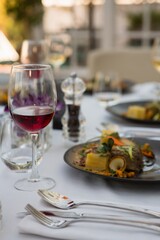 Red wine with food served on table