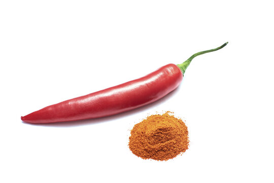 spicy chilli peppers and stack of cayenne pepper isolated on a white background