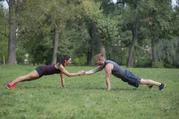 Fotobehang Persoonlijk Young woman workout with her personal trainer in park  © BGStock72