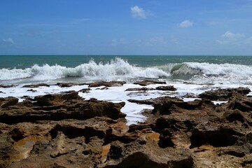 Fototapeta na wymiar Waves lapping on the reefs. Brazil