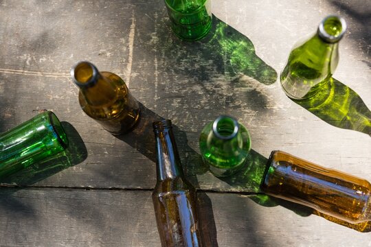 Empty beer bottles on a wooden plank