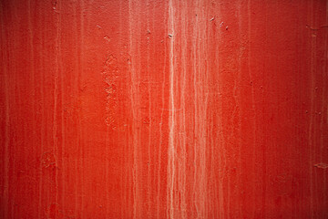dirty metal surface painted in red color illuminated by sunlight