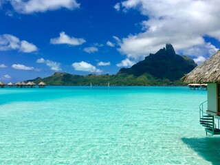 Beautiful turquoise lagoon of Bora Bora and the overwater bungalows of a luxury resort