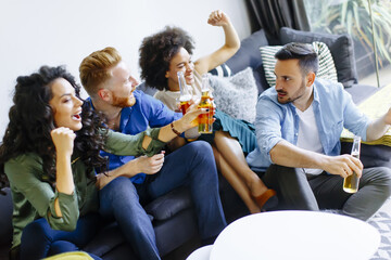 Group of male and female friends having fun at home