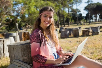Young woman using laptop in the park