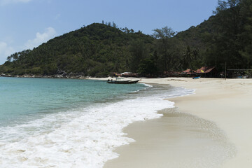 Fototapeta na wymiar Turquoise water on golden sand in the Andaman Sea