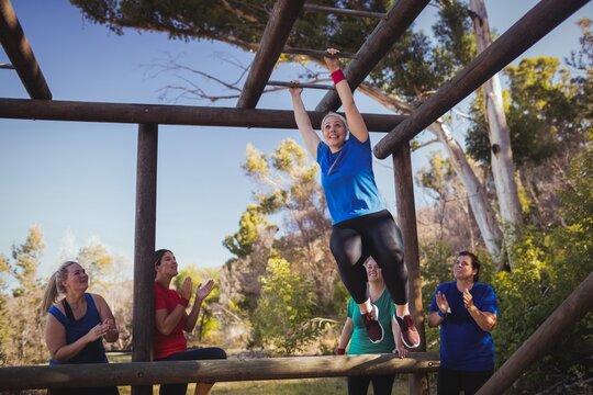 Woman being cheered by her teammates - Powered by Adobe
