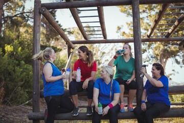 Group of women drinking water in the boot camp