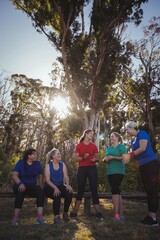 Group of fit women interacting with each other in the boot camp
