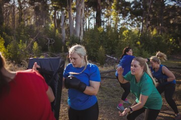 Woman practicing boxing in the boot camp
