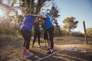 Group of women forming huddles in the boot camp