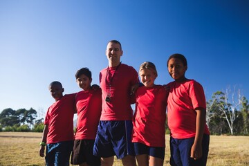 Trainer and kids standing together in the boot camp